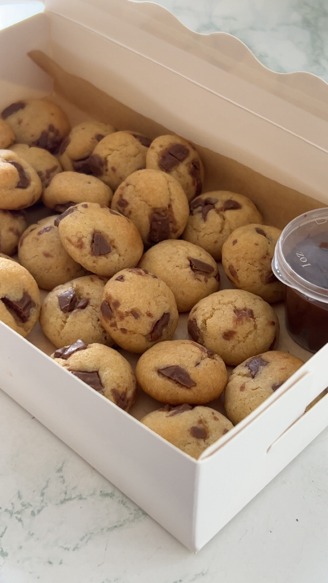Box of chocolate chip cookie bites with a pot of Biscoff dip for the Dipping Box